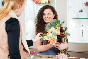 Florist holding Flowers - Lovingly Moment Makers